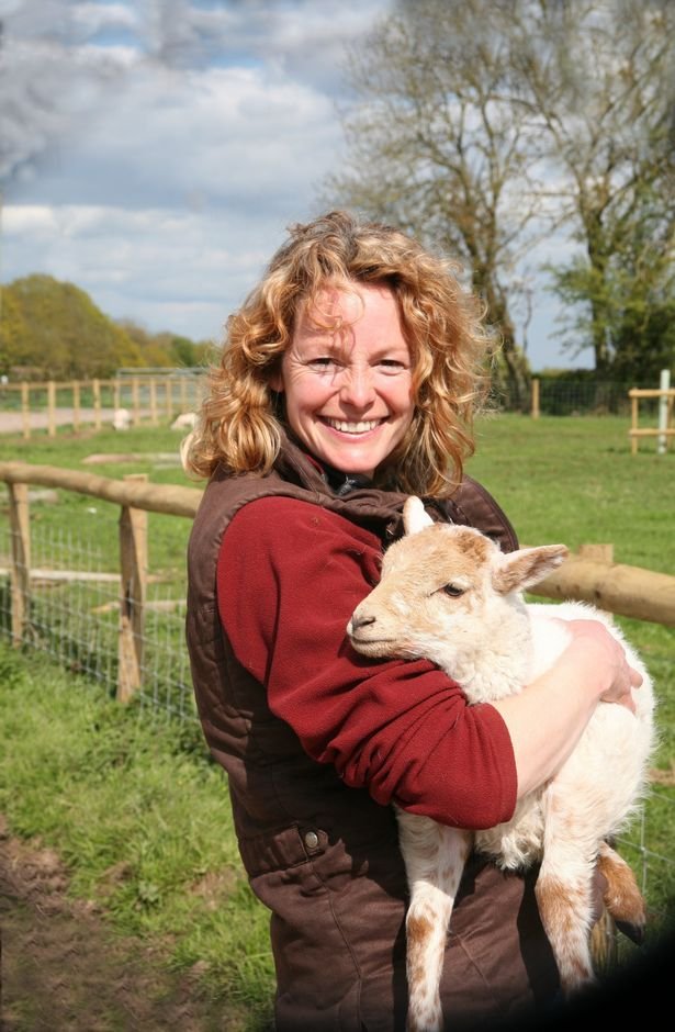 Kate Humble with a lamb on her farm in Trellech, Monmouthshire