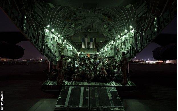 An American military plane prepares to depart Kabul airport carrying evacuees, on 21 August