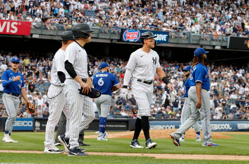 NEW YORK, NEW YORK - AUGUST 21: Aaron Judge #99 of the New York Yankees walks to first base after he was hit by a pitch from Alek Manoah #6 of the Toronto Blue Jays during the fifth inning at Yankee Stadium on August 21, 2022 in New York City. (Photo by Jim McIsaac/Getty Images)