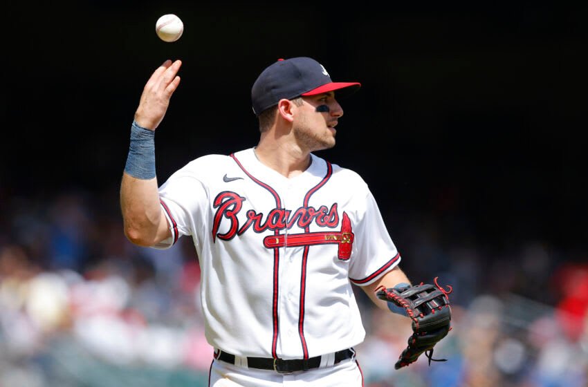 ATLANTA, GA - JULY 31: Austin Riley #27 of the Atlanta Braves tosses the ball while heading back to the dugout during the seventh inning against the Arizona Diamondbacks at Truist Park on July 31, 2022 in Atlanta, Georgia. (Photo by Todd Kirkland/Getty Images)