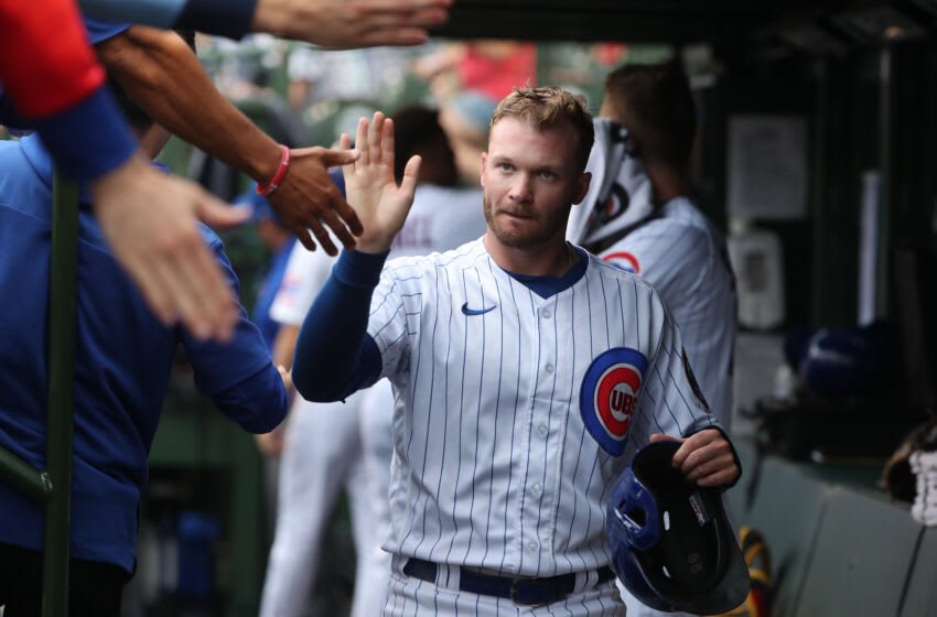 CHICAGO, ILLINOIS - JULY 17: Ian Happ #8 of the Chicago Cubs is congratulated in the dugout after scoring in the fourth inning at Wrigley Field on July 17, 2022 in Chicago, Illinois. (Photo by Chase Agnello-Dean/Getty Images)
