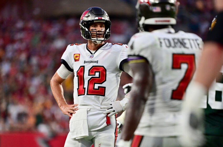 TAMPA, FLORIDA - SEPTEMBER 25: Tom Brady #12 of the Tampa Bay Buccaneers talks with Leonard Fournette #7 of the Tampa Bay Buccaneers after missing the two point conversion against the Green Bay Packers during the fourth quarter in the game at Raymond James Stadium on September 25, 2022 in Tampa, Florida. (Photo by Julio Aguilar/Getty Images)