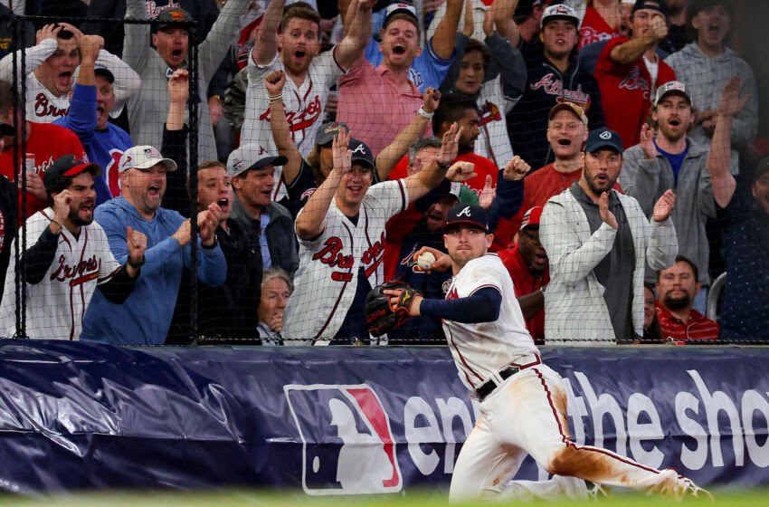 ATLANTA, GEORGIA - OCTOBER 12: Austin Riley #27 of the Atlanta Braves throws the ball after making a catch against the Philadelphia Phillies during the eighth inning in game two of the National League Division Series at Truist Park on October 12, 2022 in Atlanta, Georgia. (Photo by Kevin C. Cox/Getty Images)