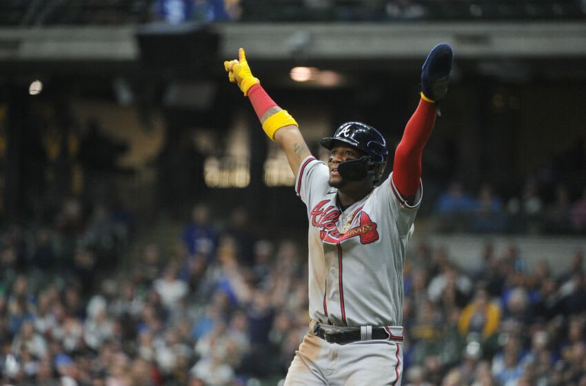 May 17, 2022; Milwaukee, Wisconsin, USA; Atlanta Braves right fielder Ronald Acuna Jr. (13) celebrates the home run of Atlanta Braves left fielder Marcell Ozuna (20) in the eighth inning against the Milwaukee Brewers at American Family Field. Mandatory Credit: Michael McLoone-USA TODAY Sports